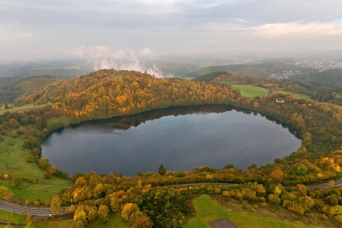Aerial view of Weinfelder Maar in the fog in autumn, rural district of Daun, Rhineland Palatinate, Germany, Europe
