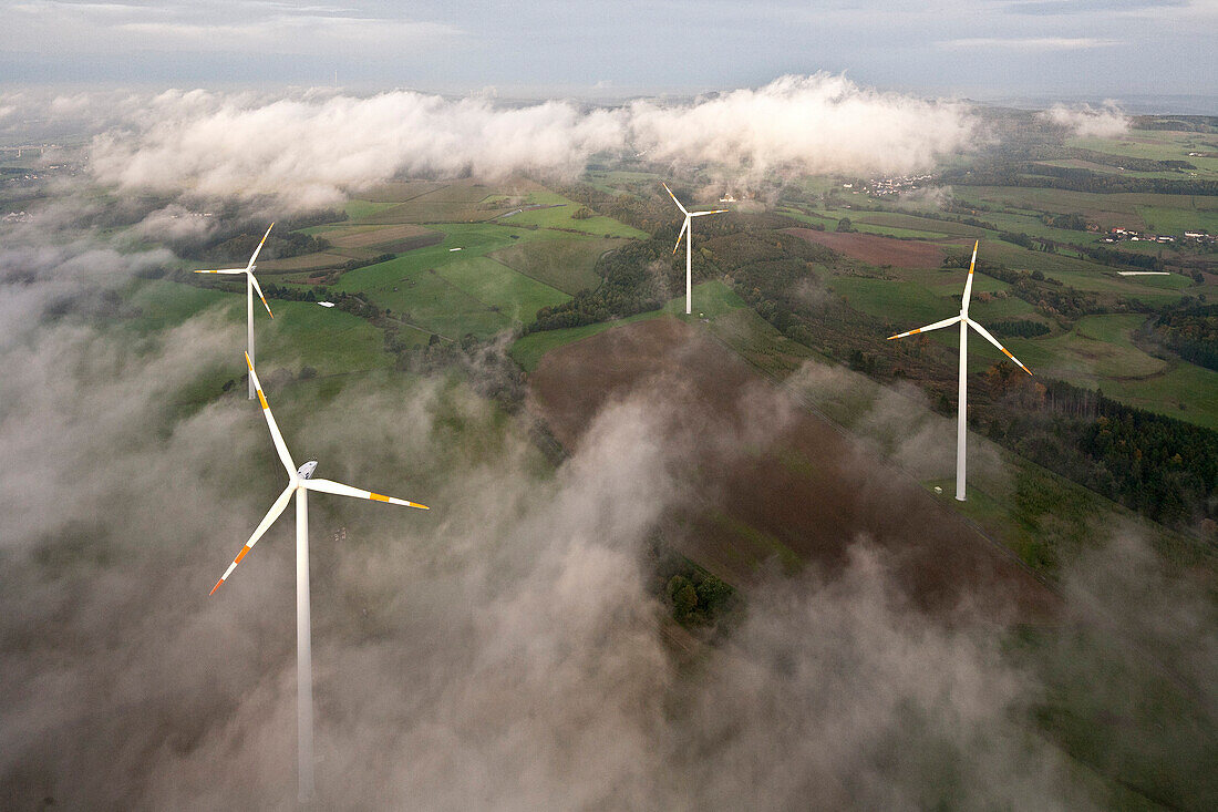 Aerial view of wind wheels at a wind turbine park in the fog, Eifel, Rhineland Palatinate, Germany, Europe