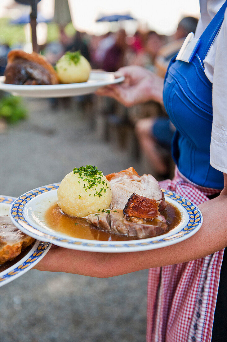 Waitress with roast pork, Weltenburg, Bavaria, Germany, Europe