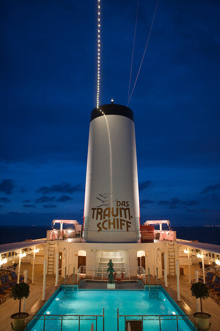 Schornstein und Pool von Kreuzfahrtschiff MS Deutschland (das ZDF Traumschiff der Reederei Peter Deilmann) in der Abenddämmerung, nahe Malmö, Südschweden, Schweden