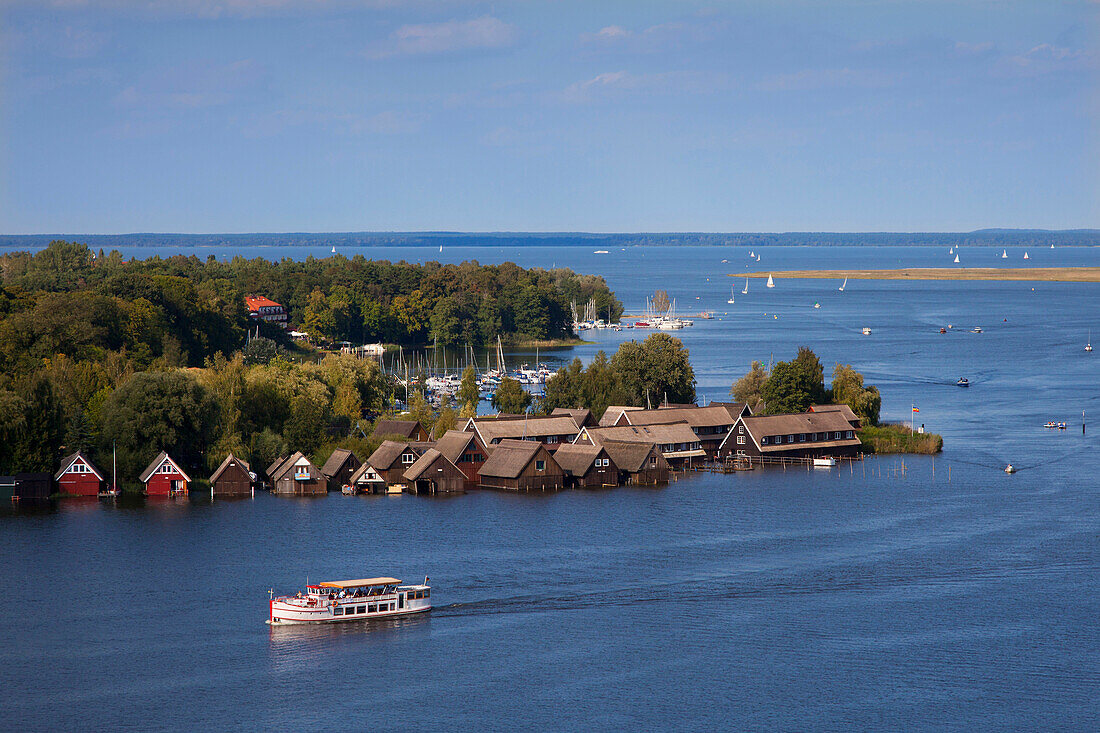 Excursion boat is passing boat houses, view over Mueritz lake, Mecklenburg lake district, Mecklenburg Western-Pomerania, Germany, Europe