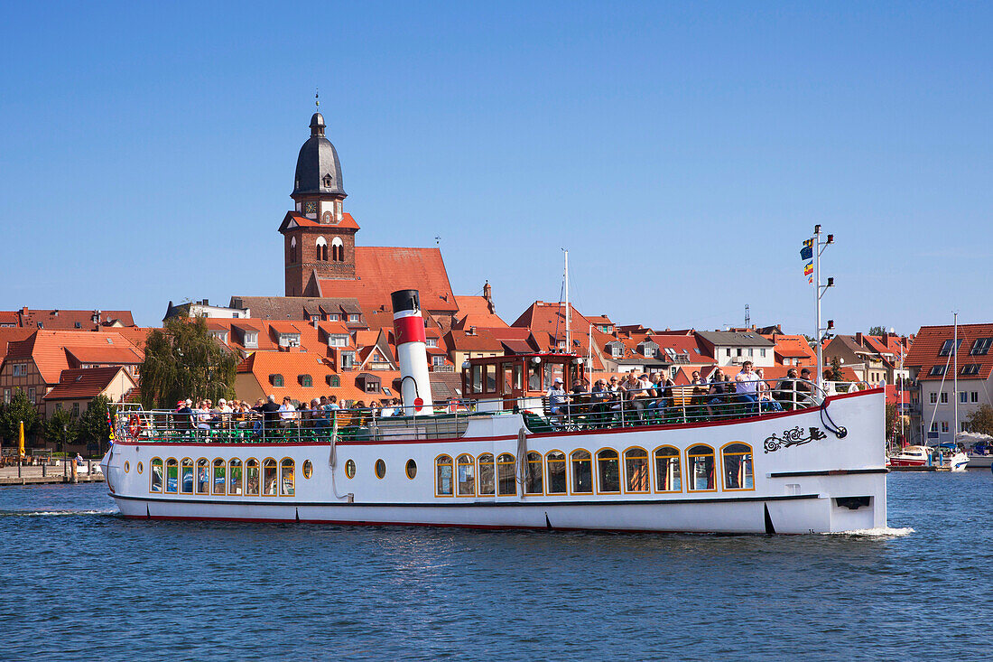 Excursion boat in front of church St. Mary, Waren at Mueritz lake, Mecklenburg lake district, Mecklenburg Western-Pomerania, Germany, Europe