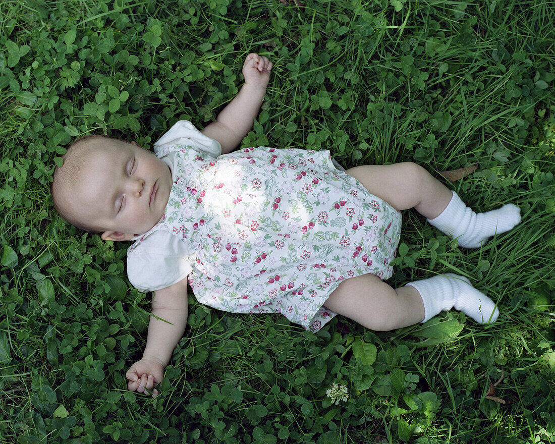Baby sleeping on grass
