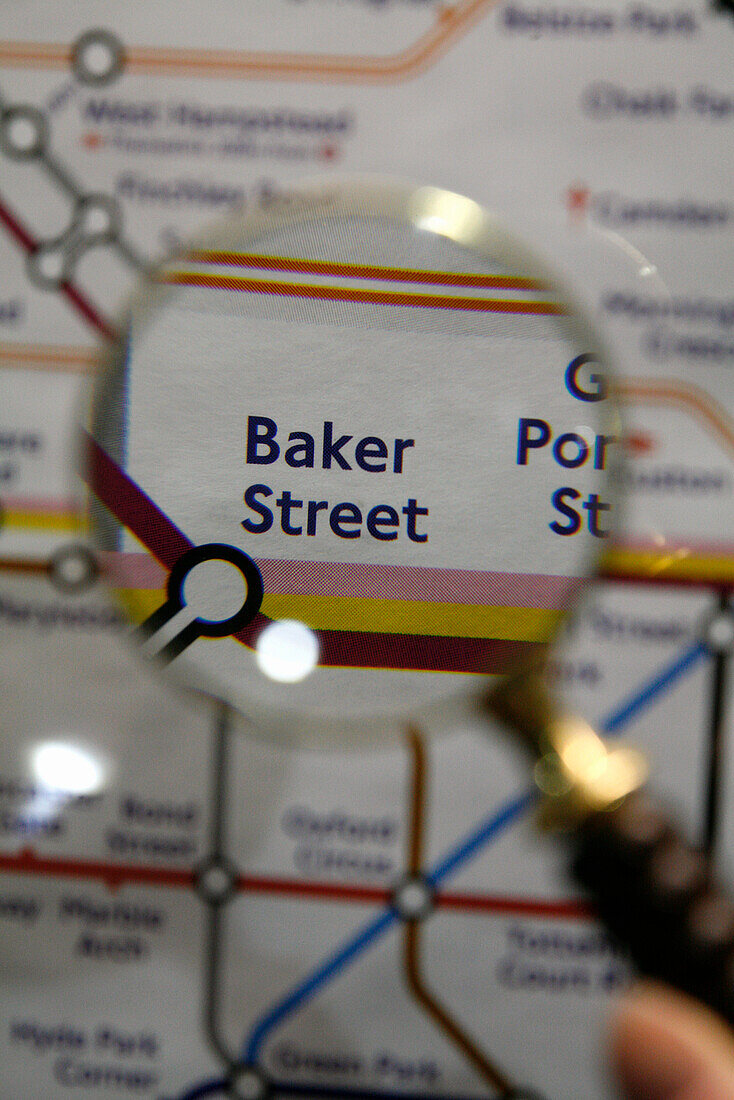 'Magnifying glass over London underground map, examining ''Baker Street'' station'
