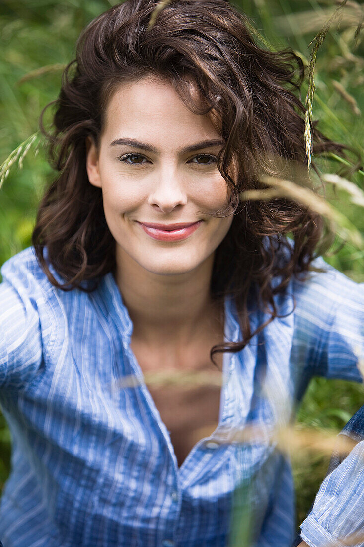 Portrait of smiling young woman, outdoors