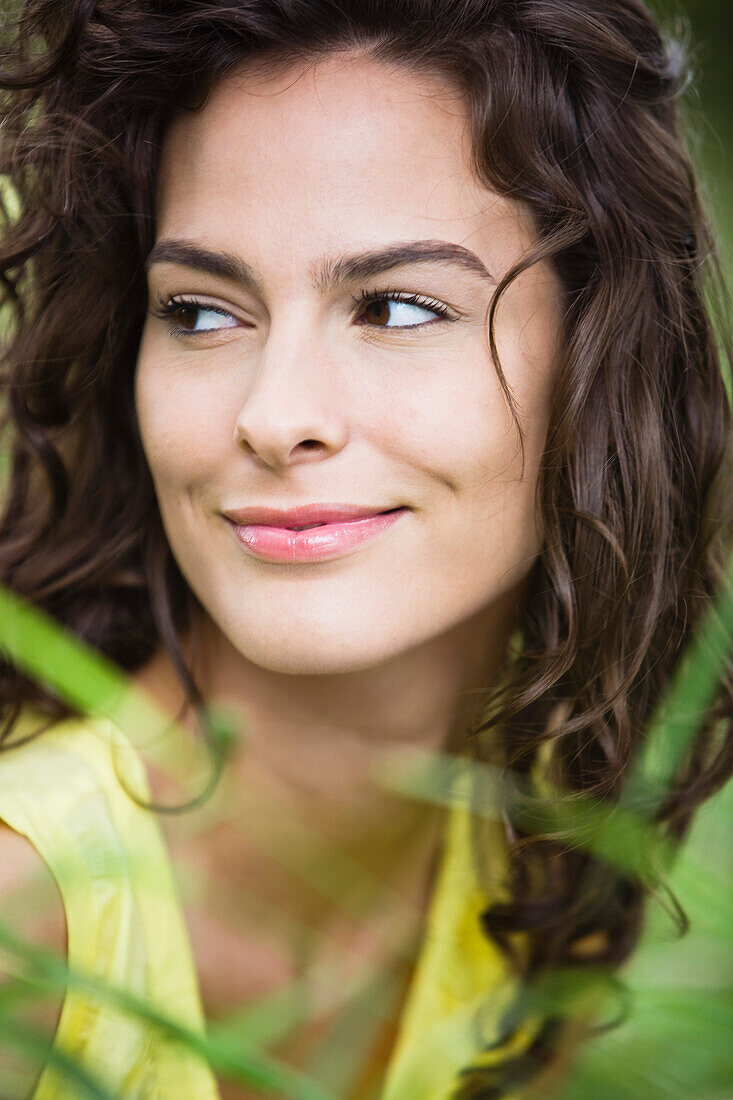 Portrait of young smiling woman, outdoors
