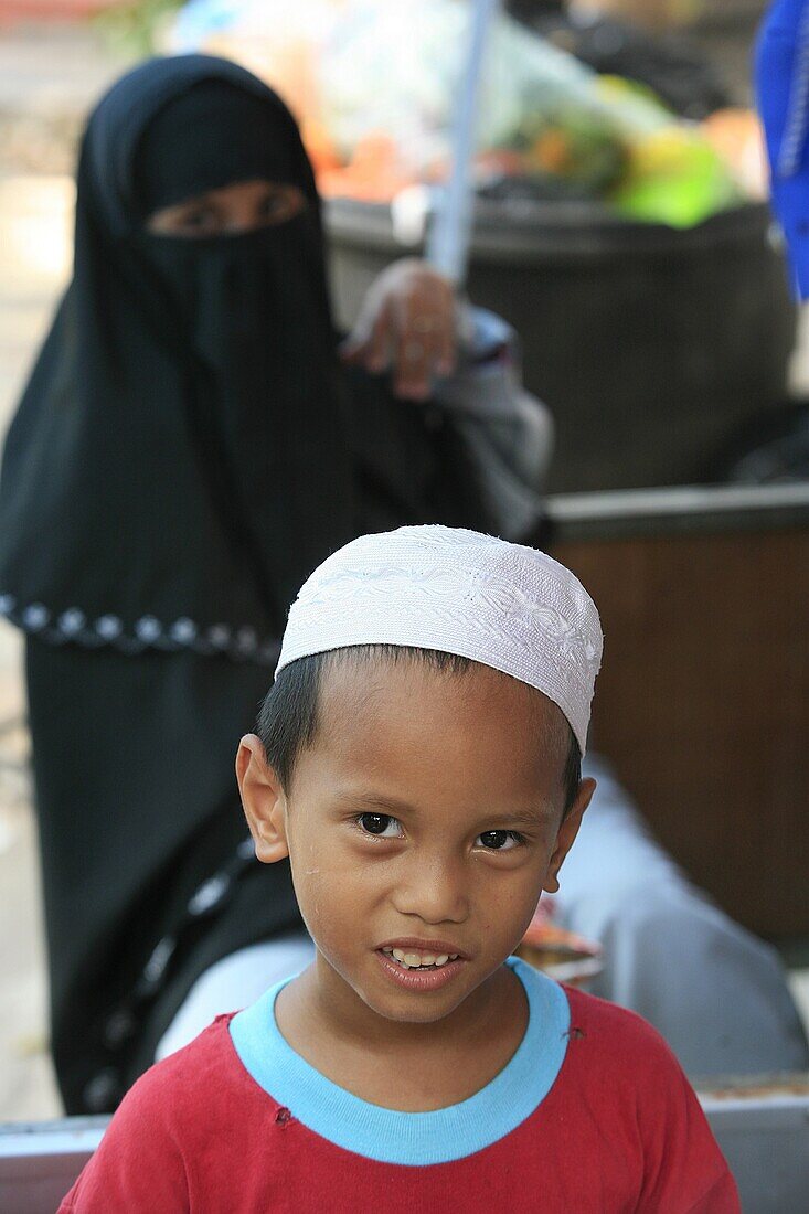 Malaysia, Kuala Lumpur, Kuala Lumpur, Young muslim boy and his mother.