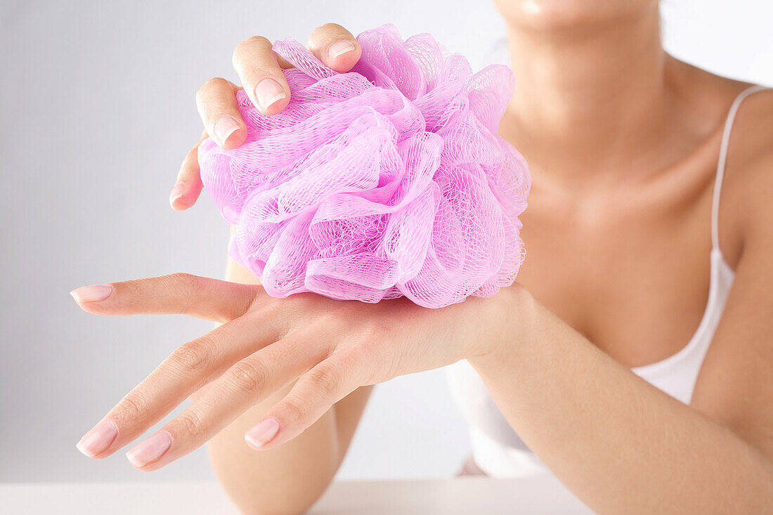 Woman holding a pink sponge