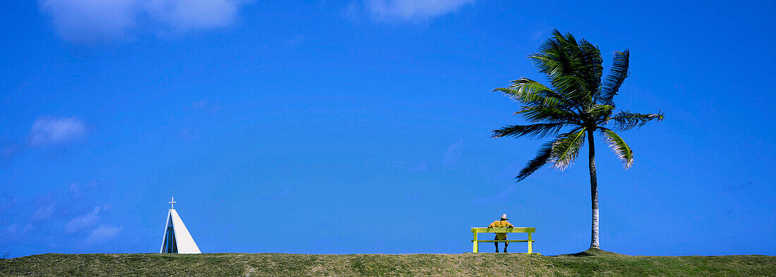 West Indies, Martinique, Vauclin, man on a bench, palm tree