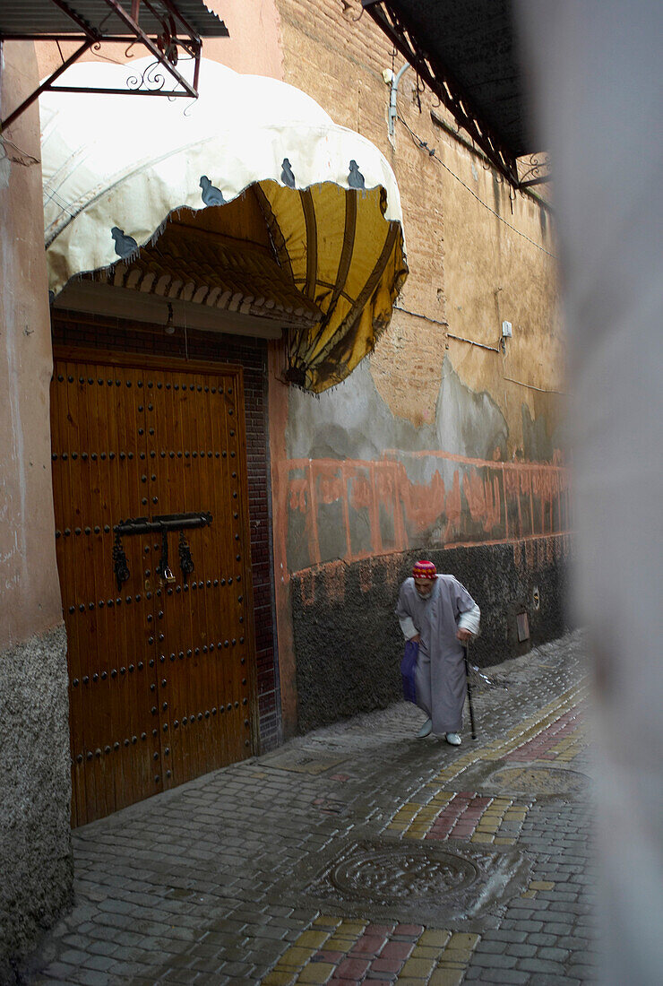 Old Man in Traditional Clothing Walking in Medina, Marrakesh, Morocco