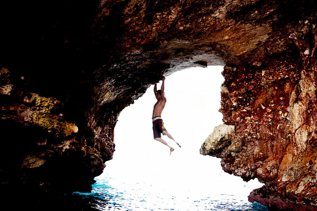 Male Rock Climber in Sea Cave, Mallorca, Spain