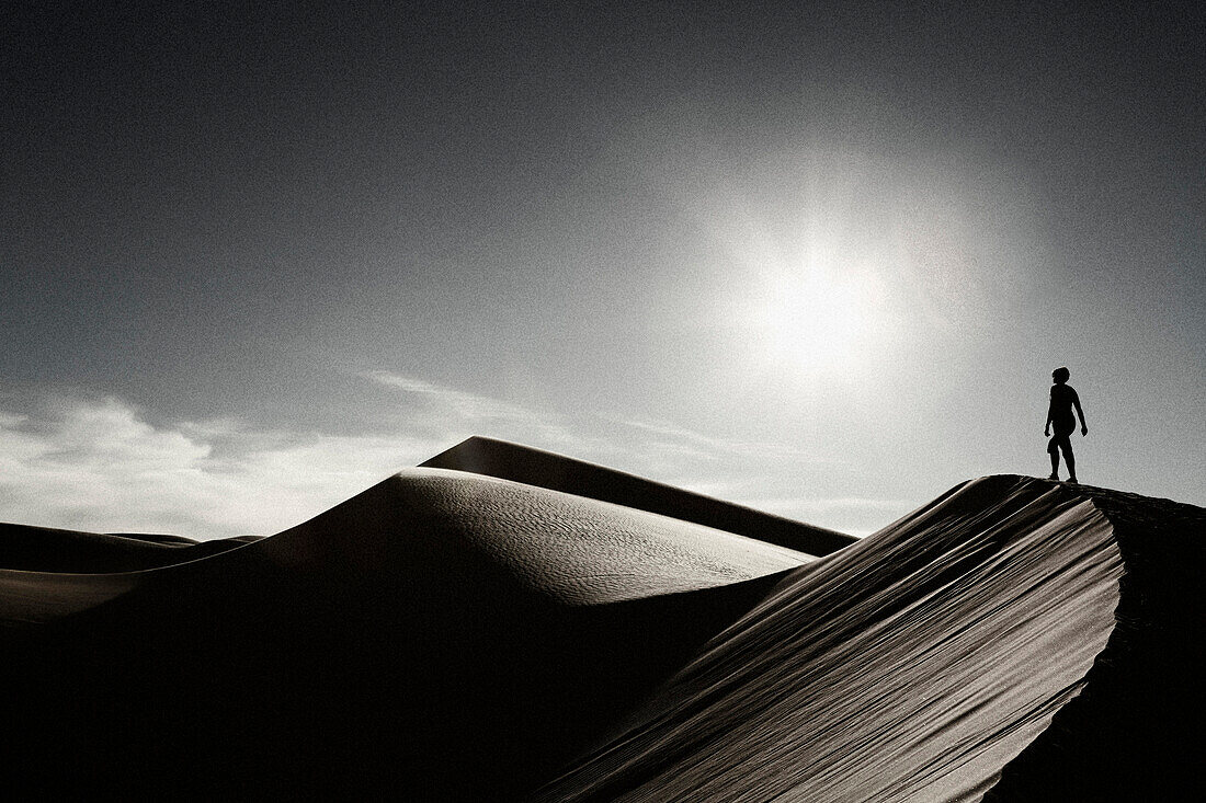 Woman Walking on Desert Sand Dune, California, USA