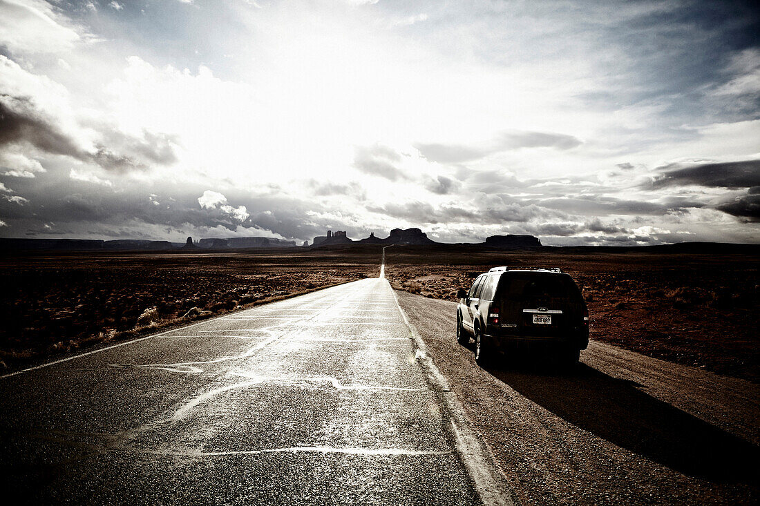 Car and Road South Through Monument Valley, Utah, USA