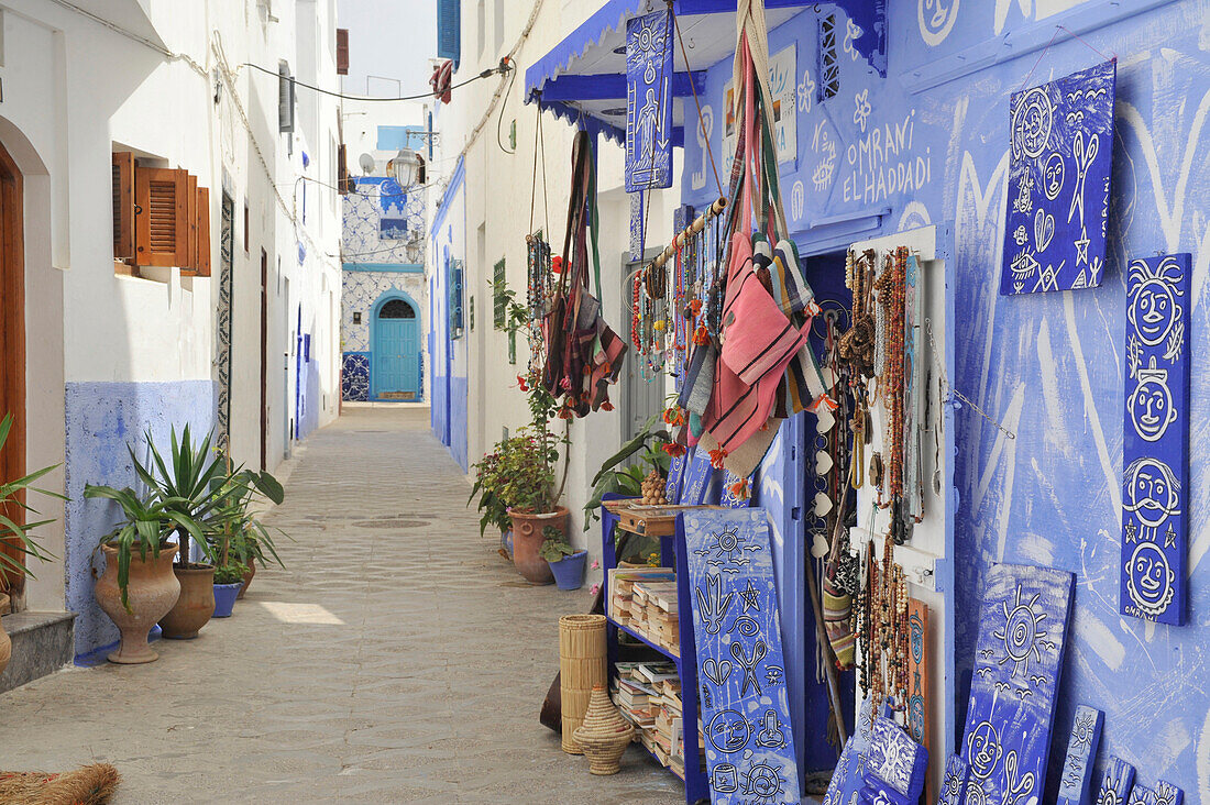 Blue paintings on the walls of a house and shop in the old town of Asilah, Atlantic Coast, Morocco, Africa