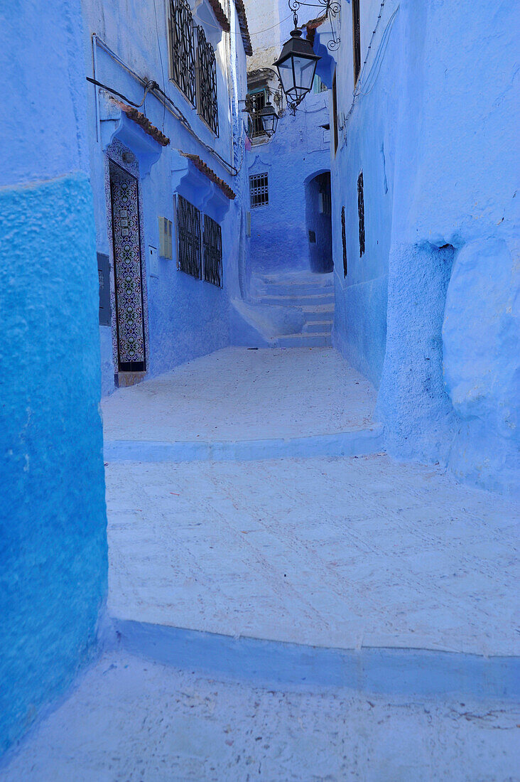 Blue walls and doors in a narrow alley at Chefchaouen, Riff mountains, Morocco, Africa
