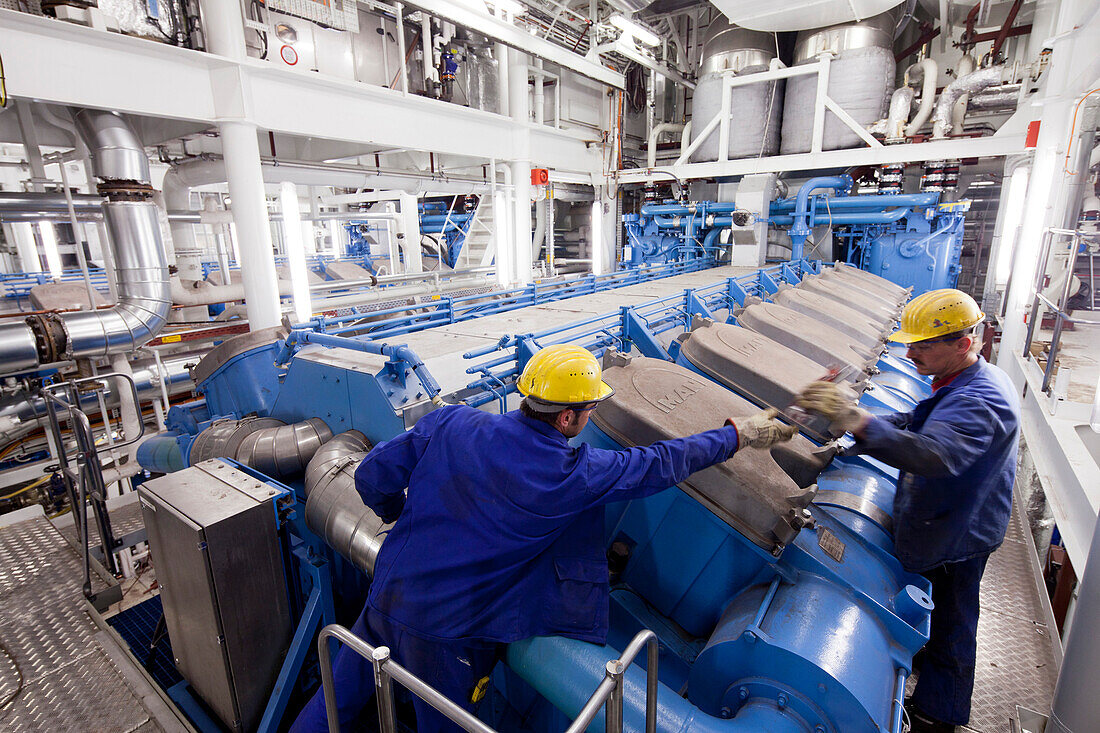 Assemblers in engine room, cruiser under construction in dry dock, Meyer Werft, Papenburg, Lower Saxony, Germany