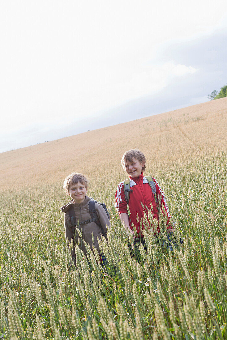 Two boys in grain field, Lankau, Schleswig-Holstein, Germany