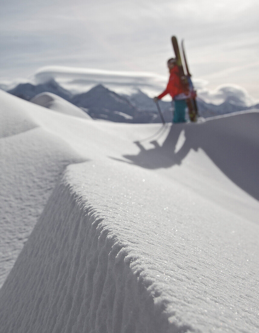 Female skier ascending through deep snow, Chandolin, Anniviers, Valais, Switzerland