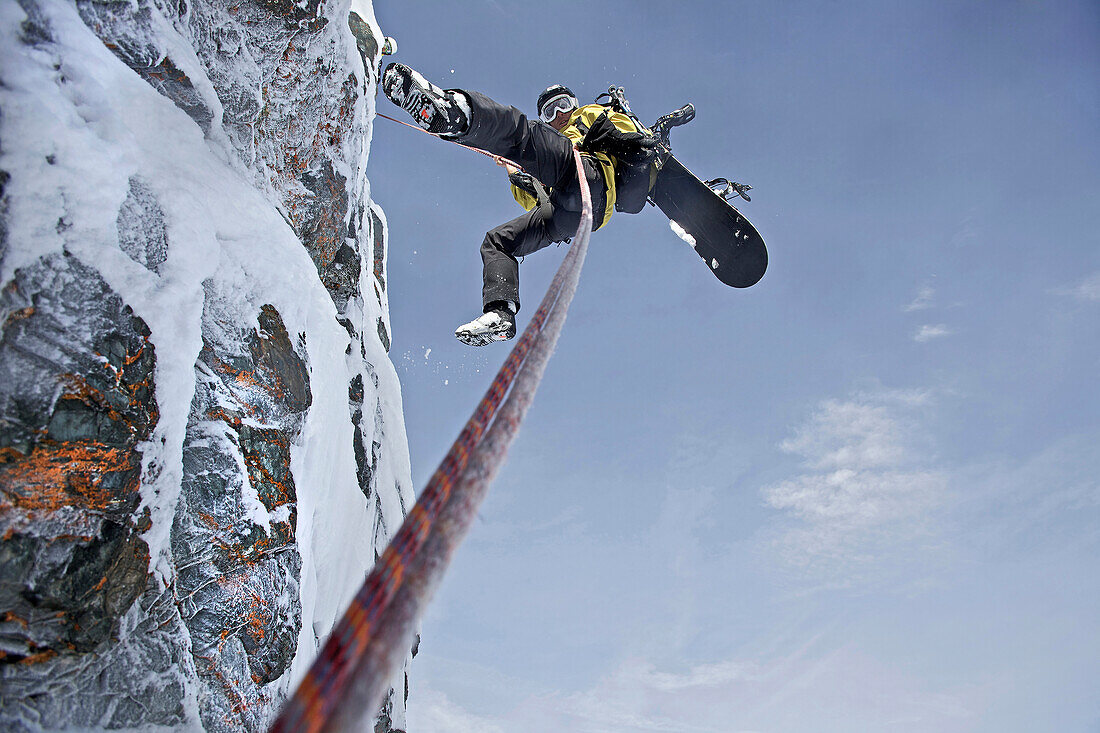 Snowboarder rappeling, Chandolin, Anniviers, Valais, Switzerland