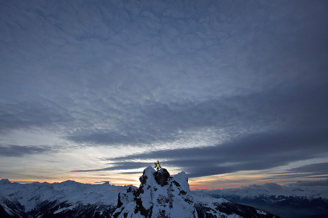 Snowboarder standing on a mountain in twilight, Chandolin, Anniviers, Valais, Switzerland