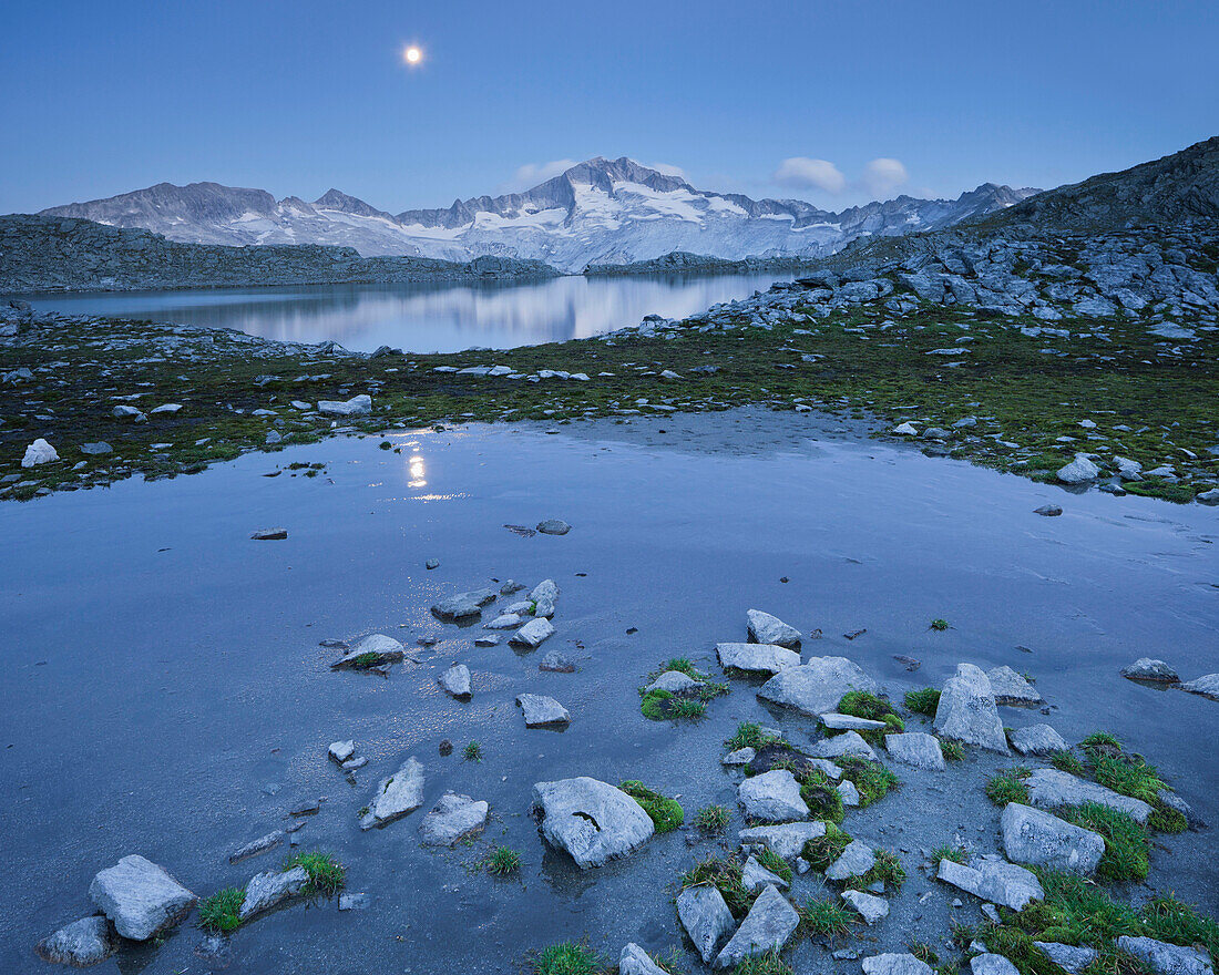 Full moon above lake Schwarzhornsee, Hochalmspitze, Hohe Tauern National Park, Carinthia, Austria, Europe