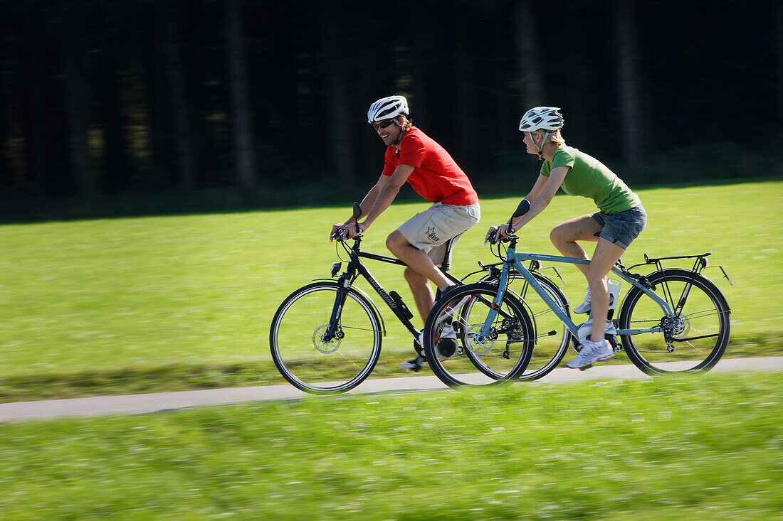 Cyclists riding e-bikes, Lake Starnberg, Bavaria, Germany