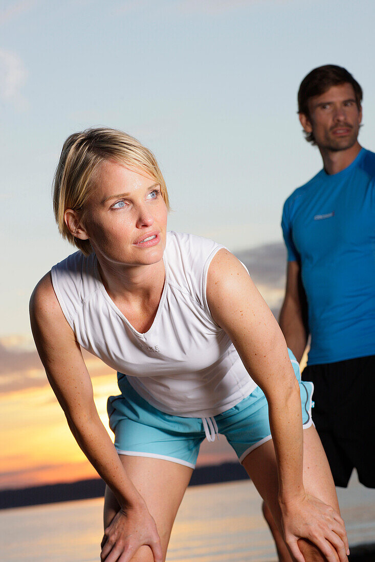 Couple wearing sports clothing at lake Starnberg, Bavaria, Germany