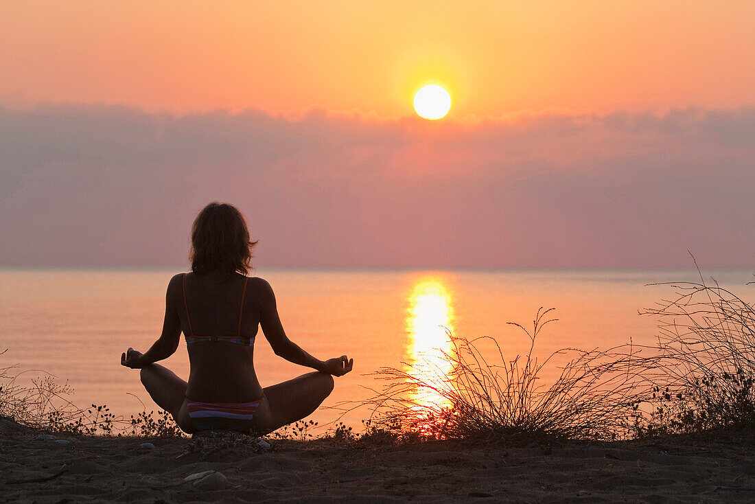Woman practising Yoga at sunrise, Mediterranean Sea, Lykia, Turkey, Europe