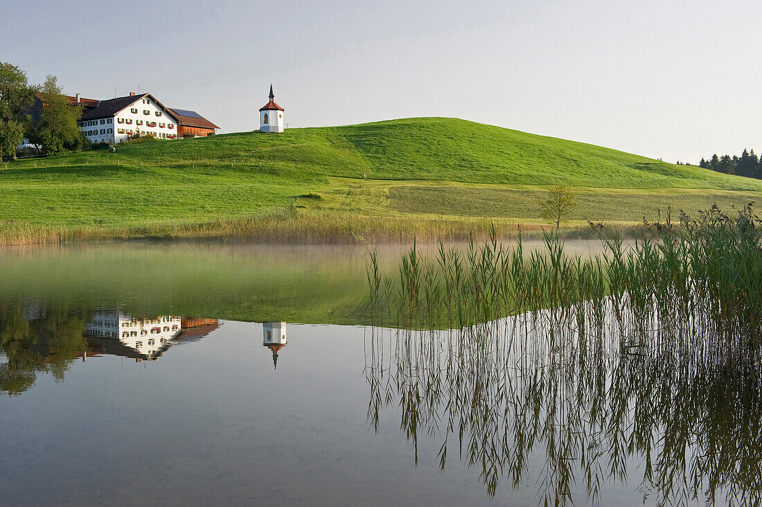 View over lake Hegratsried to chapel royal, Halblech, Allgaeu, Bavaria, Germany