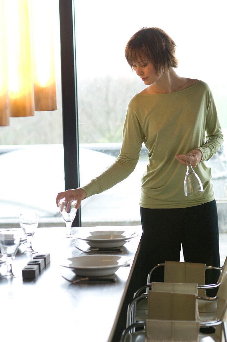 Young woman setting the table