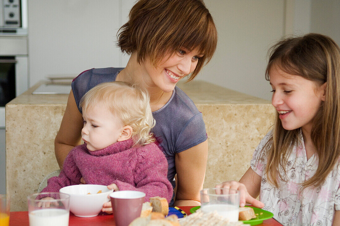 Woman and 2 children at breakfast table