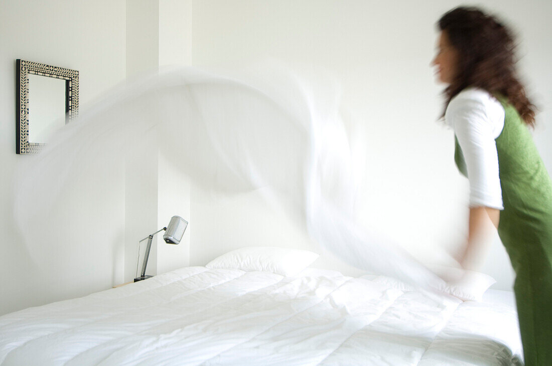 Woman making a bed