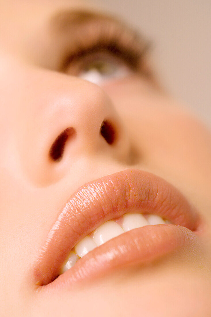 Woman looking up, close-up of her mouth, indoors(studio)