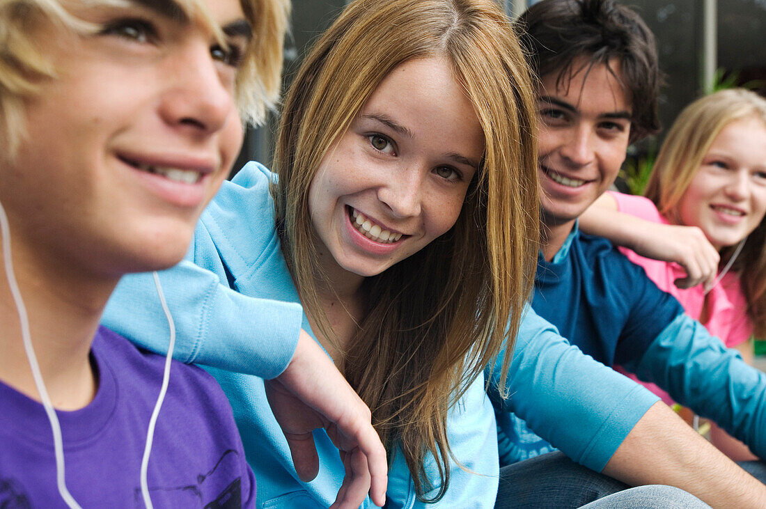 2 teenage boys and 2 teenage girls smiling for camera