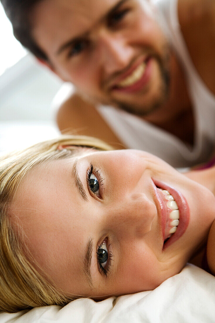 Young smiling couple in bed