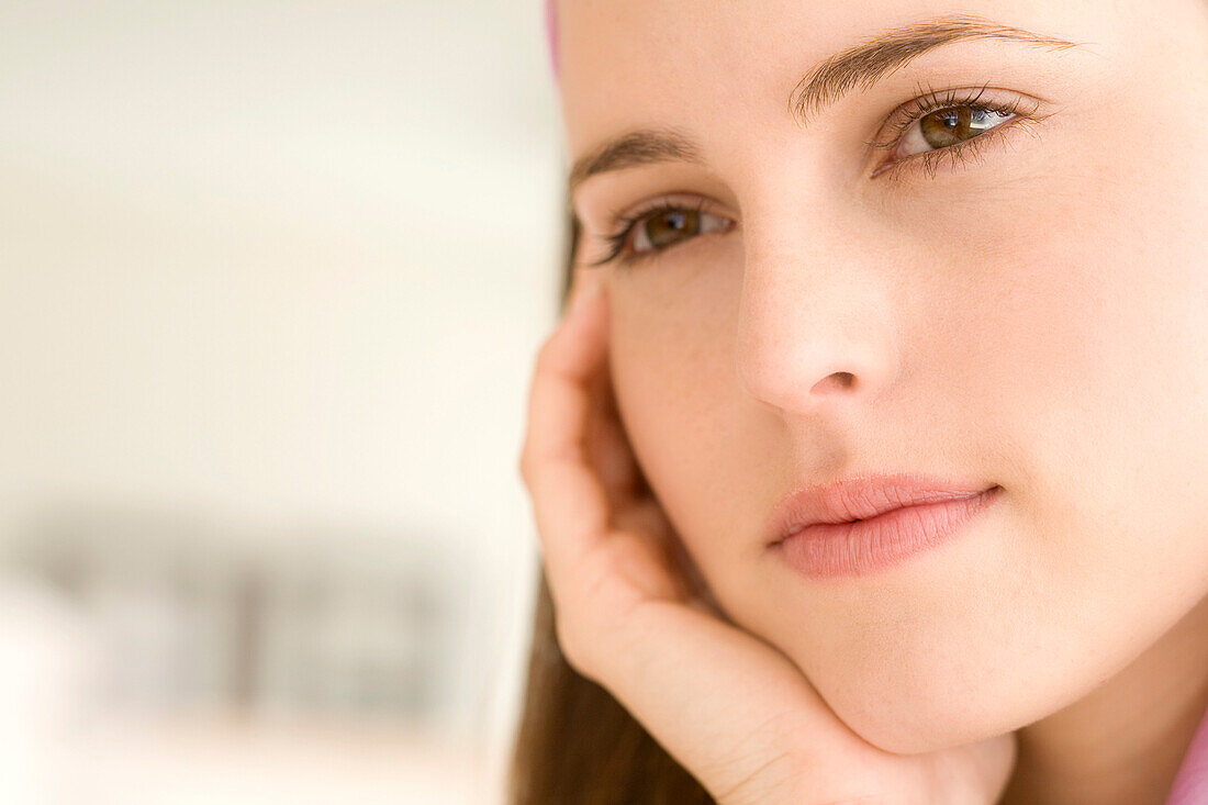 Portrait of a thoughtful young woman, indoors