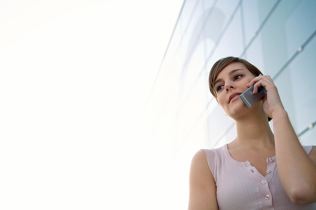 Low angle view of a young woman talking on a mobile phone