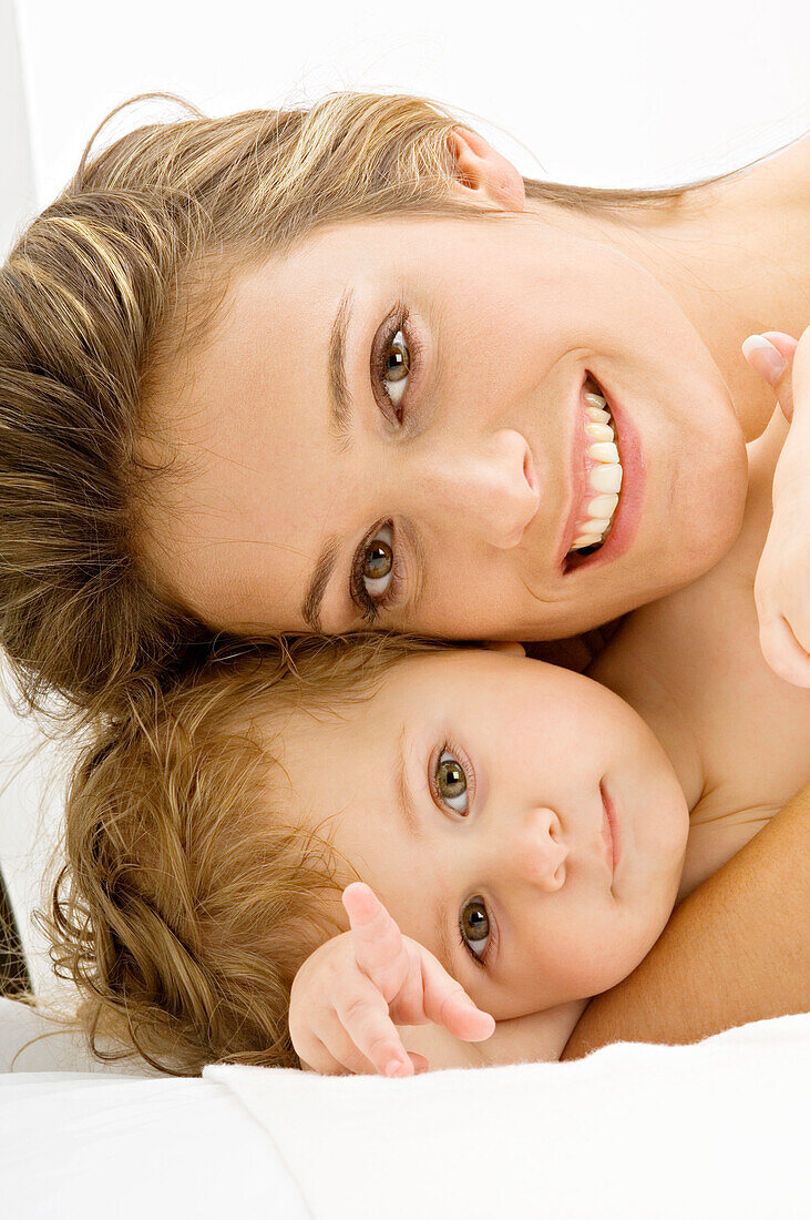 Portrait of a young woman smiling with her son