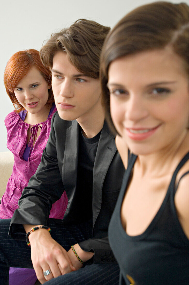 Portrait of two young women with a teenage boy