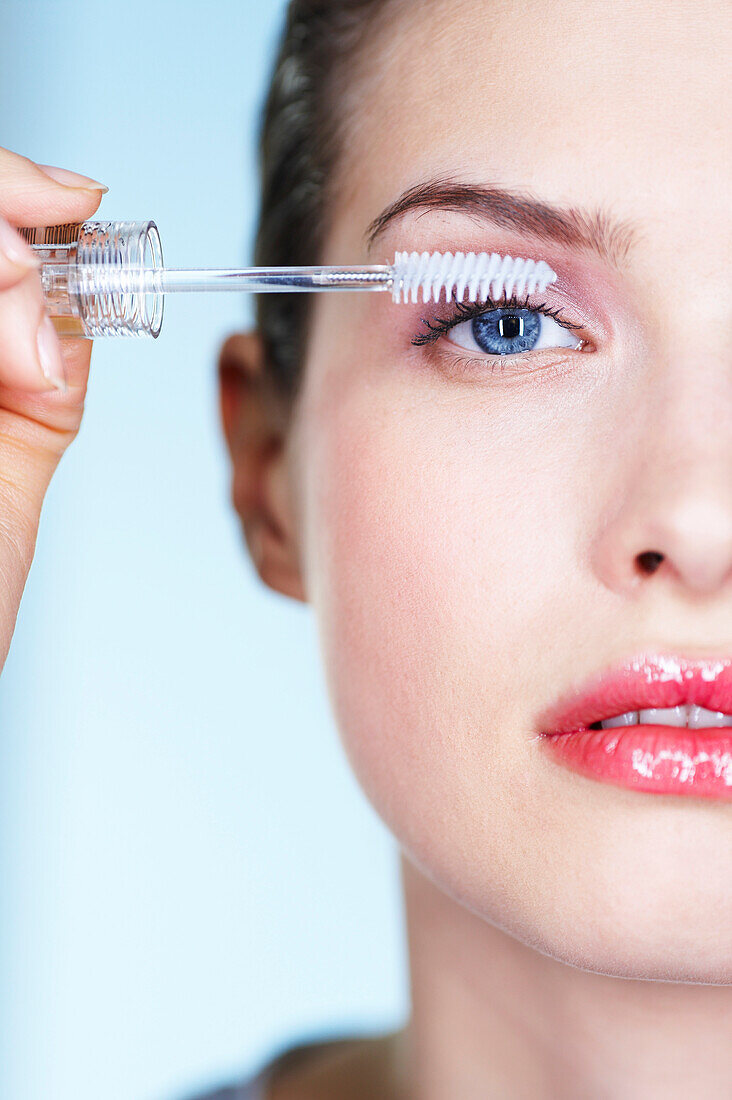 Woman applying mascara