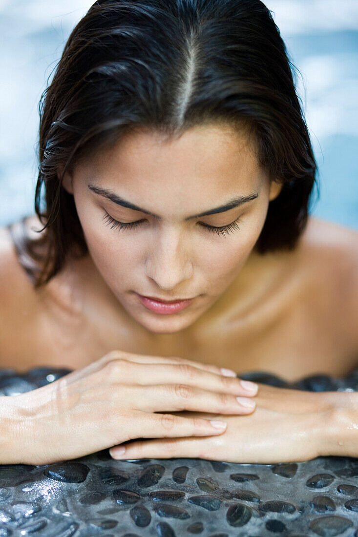 Woman leaning at the poolside