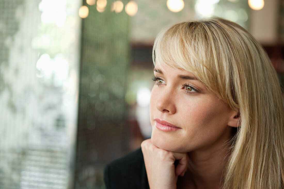 Woman thinking in a cafe