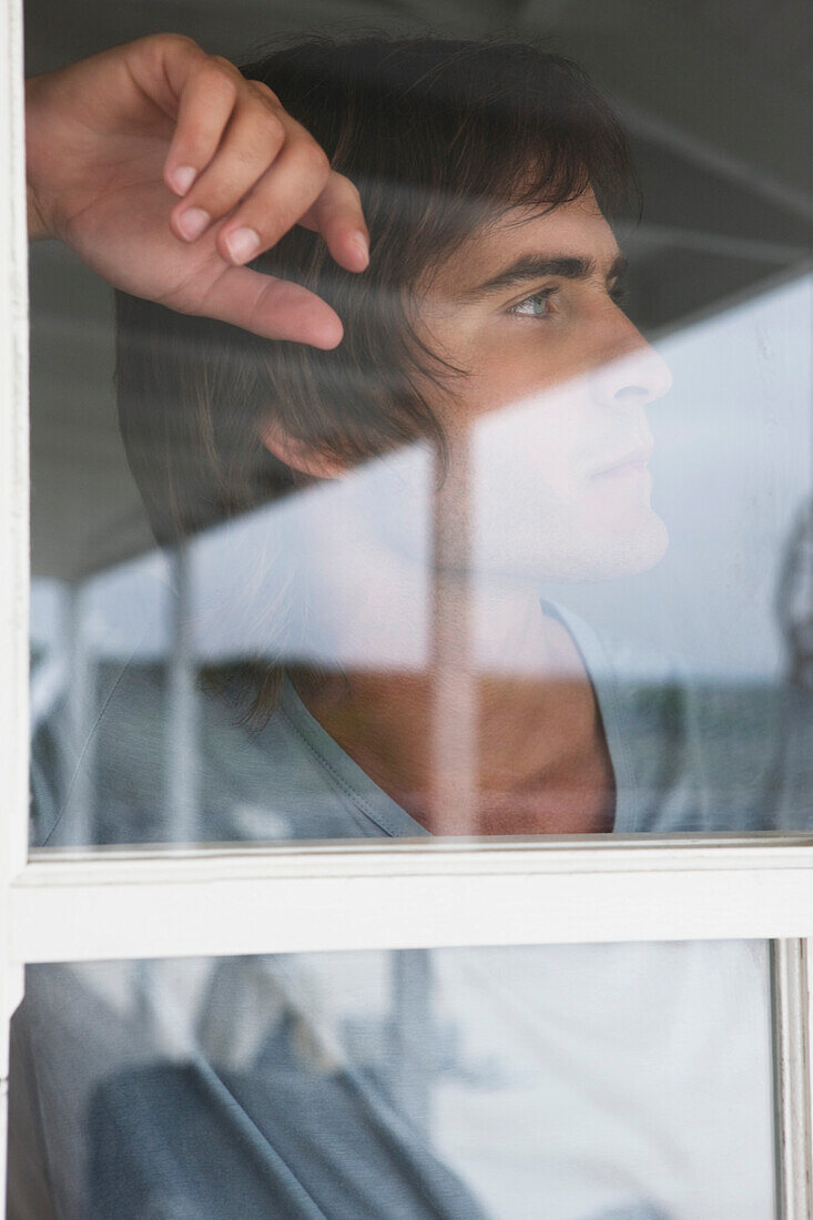 Man looking through glass window