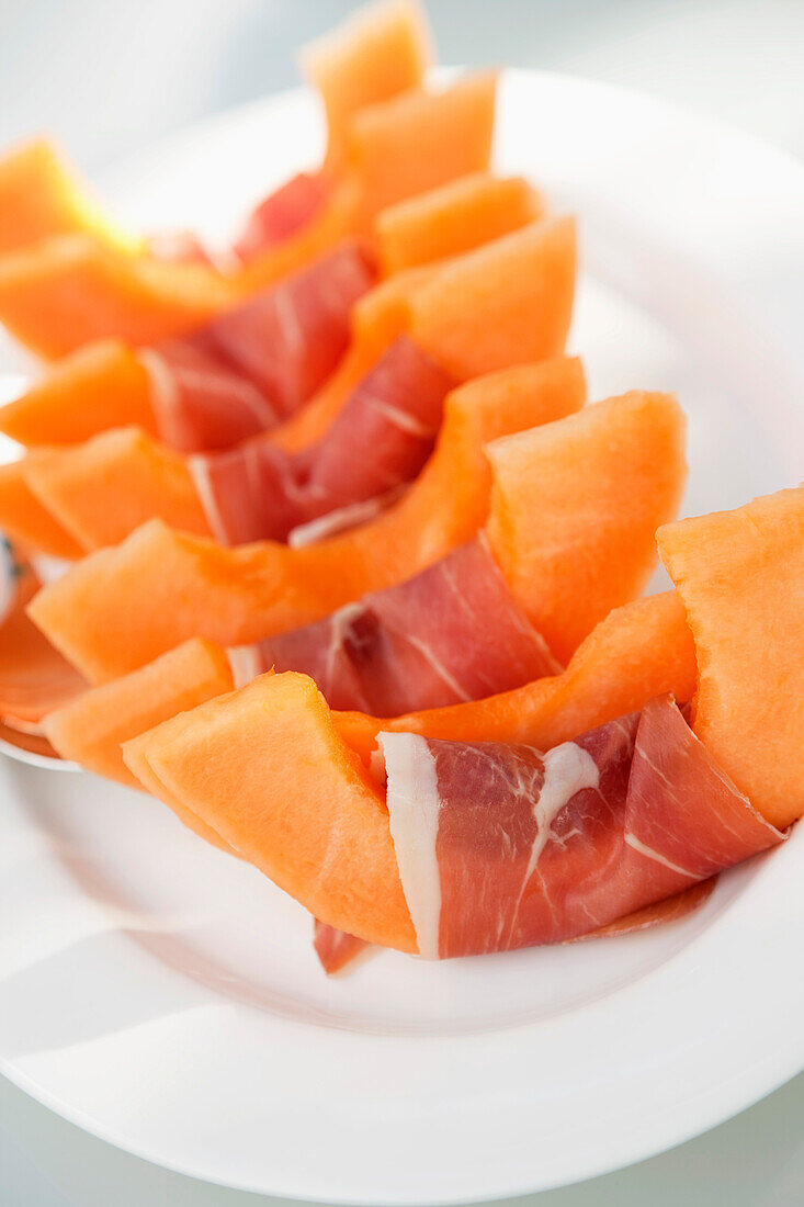 Slices of muskmelon wrapped in ham