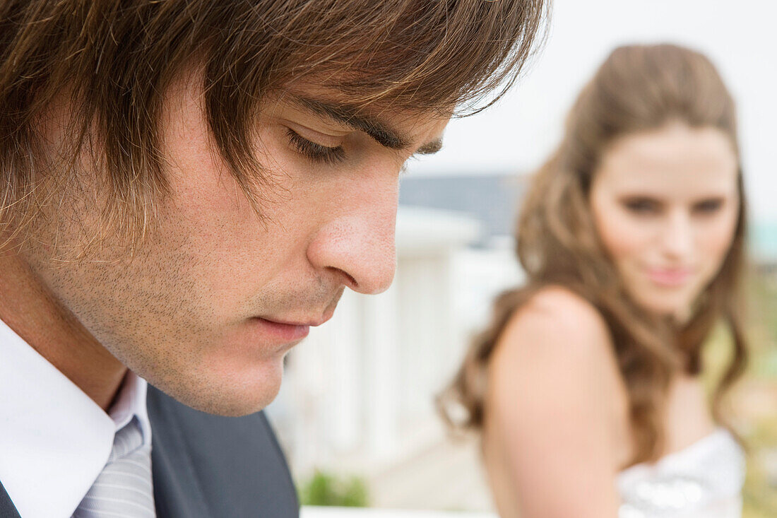 Close-up of a groom beside a bride