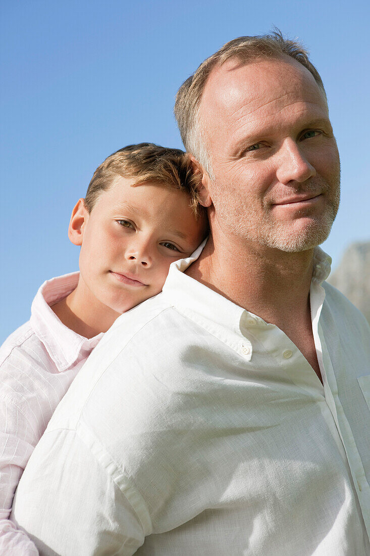 Boy riding piggyback on his father