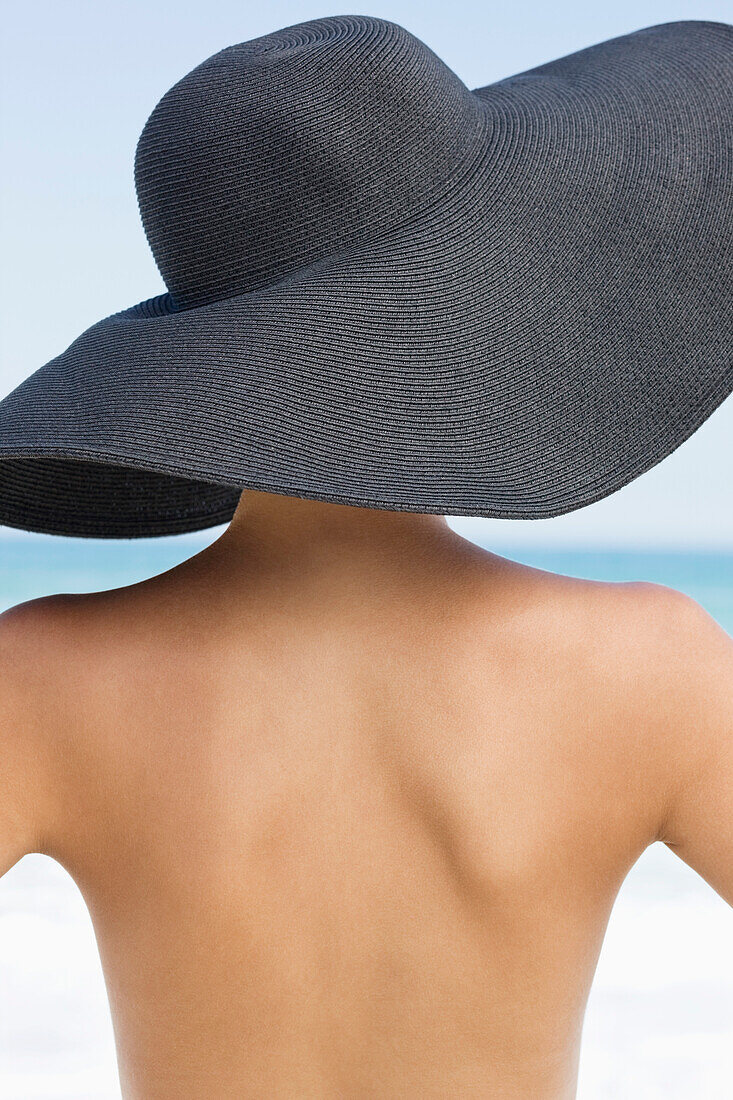 Rear view of a woman wearing hat on the beach
