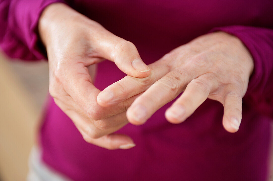 Close-up of a woman suffering from finger pain