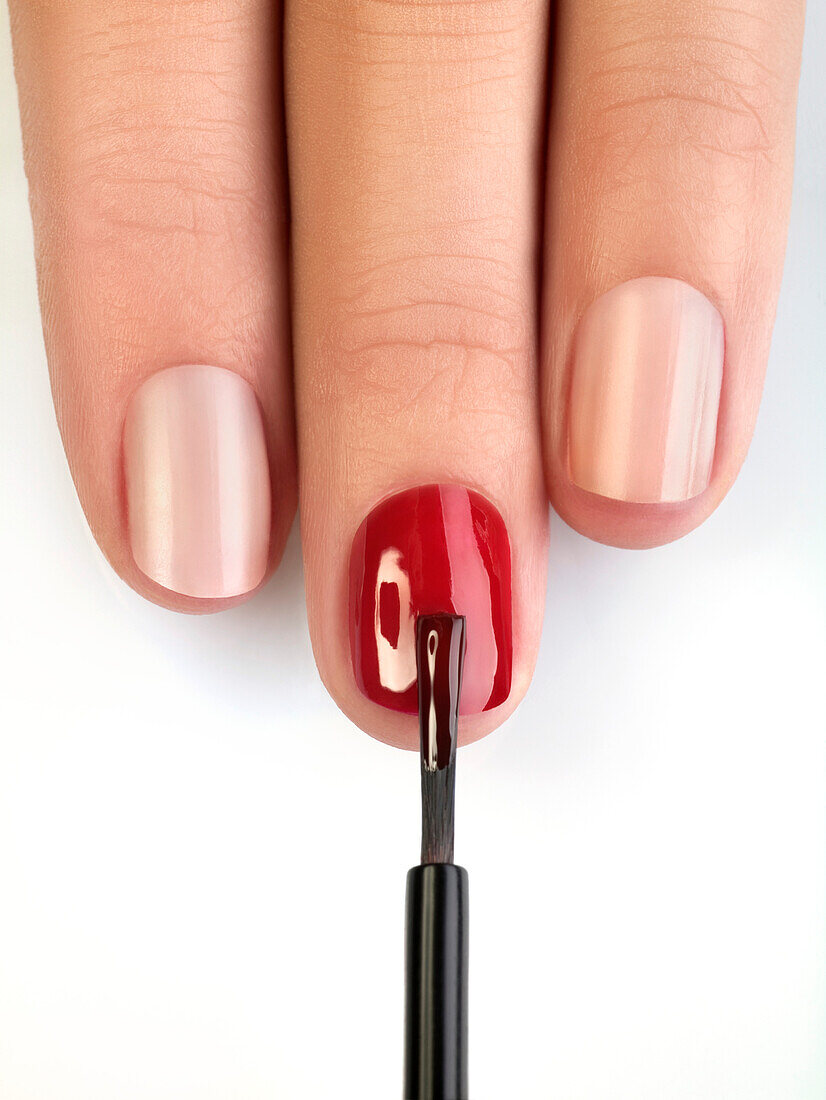 Woman painting fingernails, close-up