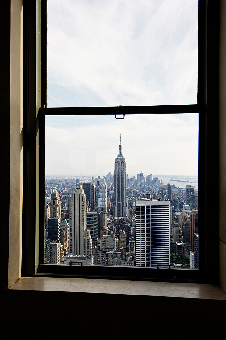 View out of a window onto Empire State Building and Rockefeller Center, Manhattan, New York, USA, America